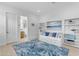 Bright bedroom features a comfortable daybed, decor shelving and blue-toned accent rug at 4247 S Zenith --, Mesa, AZ 85212