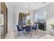 Bright dining area featuring a modern light fixture, a round table, and stylish blue chairs near sliding glass doors at 4247 S Zenith --, Mesa, AZ 85212