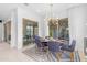 Bright dining area featuring a modern light fixture, a round table, and stylish blue chairs near sliding glass doors at 4247 S Zenith --, Mesa, AZ 85212