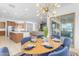 Bright dining area features stylish light fixture, seating for six, and access to the outdoor patio at 4247 S Zenith --, Mesa, AZ 85212