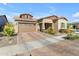 A beautiful home featuring desert landscaping, brown accents, and a brick-paved driveway at 4247 S Zenith --, Mesa, AZ 85212