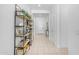 Bright hallway featuring open shelving and light tile floors leading to the front door and other rooms at 4247 S Zenith --, Mesa, AZ 85212