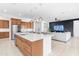 Open concept kitchen and living room space with center island, wood cabinets and stainless steel appliances at 4247 S Zenith --, Mesa, AZ 85212