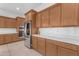 A stylish kitchen featuring stainless steel appliances, wooden cabinets, and bright white countertops at 4247 S Zenith --, Mesa, AZ 85212