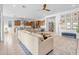 Open-concept living area featuring a large sectional sofa, stylish decor, and a view of the modern kitchen at 4247 S Zenith --, Mesa, AZ 85212