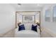 Bright main bedroom featuring a stylish bed frame, neutral rug and décor, with a comfortable seating area at 4247 S Zenith --, Mesa, AZ 85212