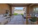 Covered patio with outdoor dining area, seating, and view of the pool and lush backyard at 4247 S Zenith --, Mesa, AZ 85212