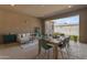 Inviting covered patio with dining table, seating, and backyard access, perfect for outdoor relaxation and entertaining at 4247 S Zenith --, Mesa, AZ 85212