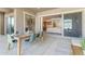 Covered patio boasts concrete flooring and a wood table setting with sliding glass doors leading indoors at 4247 S Zenith --, Mesa, AZ 85212