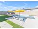 Lush backyard featuring a stunning pool, outdoor lounge chairs, and well-manicured artificial grass at 4247 S Zenith --, Mesa, AZ 85212