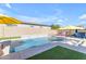 A luxurious backyard pool is beautifully accented with a waterfall feature and green grass at 4247 S Zenith --, Mesa, AZ 85212