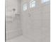 Elegant walk-in shower with white tile, a shower bench and modern fixtures at 4247 S Zenith --, Mesa, AZ 85212