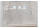 Modern walk-in shower with glass enclosure, white tile, and sleek fixtures at 4247 S Zenith --, Mesa, AZ 85212