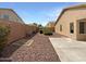 Low maintenance backyard with rock landscaping, block wall and patio at 44271 W Oster Dr, Maricopa, AZ 85138
