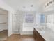 Bright bathroom featuring dual sinks, walk-in shower, and tub at 44271 W Oster Dr, Maricopa, AZ 85138