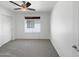 Cozy bedroom with neutral carpet, a ceiling fan, and a window at 44271 W Oster Dr, Maricopa, AZ 85138