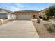Single-Gathering home with a two-car garage and desert landscaping at 44271 W Oster Dr, Maricopa, AZ 85138