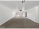 Spacious living room with neutral carpet and lots of natural light at 44271 W Oster Dr, Maricopa, AZ 85138
