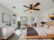 Cozy main bedroom with ceiling fan and ensuite bath access at 44271 W Oster Dr, Maricopa, AZ 85138