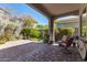 Cozy backyard with brick pavers, mature landscaping, and covered seating area at 4516 E Walter Way, Phoenix, AZ 85050