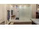 Bright bathroom featuring a walk-in shower with glass door and a view into the primary bedroom at 4516 E Walter Way, Phoenix, AZ 85050