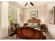 Charming bedroom featuring vintage furniture, a ceiling fan, and a view into the backyard at 4516 E Walter Way, Phoenix, AZ 85050
