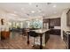 Open kitchen featuring dark cabinets, stainless steel appliances, large island, and breakfast bar seating at 4516 E Walter Way, Phoenix, AZ 85050