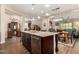 Spacious kitchen with large island, granite counters, stainless steel appliances, and wood-look tile flooring at 4516 E Walter Way, Phoenix, AZ 85050