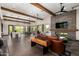 Spacious living area with wooden beams, fireplace, and modern decor for comfortable community gatherings at 4516 E Walter Way, Phoenix, AZ 85050