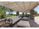 Stylish outdoor lounge area with comfortable seating, a pergola, and views of the surrounding green space at 4516 E Walter Way, Phoenix, AZ 85050