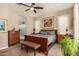 Inviting primary bedroom with ceiling fan, large windows, and a view into the bathroom at 4516 E Walter Way, Phoenix, AZ 85050