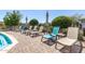 Relaxing poolside area with lounge chairs and umbrellas, perfect for enjoying sunny days by the community pool at 4516 E Walter Way, Phoenix, AZ 85050