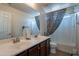 Bright bathroom features a double sink vanity and a tub with a shower at 5139 W Shumway Farm Rd, Laveen, AZ 85339