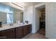 Modern bathroom features double vanity, framed mirror and white cabinets at 5139 W Shumway Farm Rd, Laveen, AZ 85339