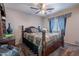 Comfortable bedroom with a ceiling fan and a window showcasing a custom valance at 5139 W Shumway Farm Rd, Laveen, AZ 85339