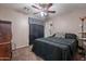 This cozy bedroom features a ceiling fan, neutral walls, and dark wood furnishings at 5139 W Shumway Farm Rd, Laveen, AZ 85339