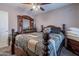Well lit bedroom with a ceiling fan and a wooden four post bed at 5139 W Shumway Farm Rd, Laveen, AZ 85339