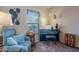 Comfortable bonus room with a piano, globe, and cozy blue recliner at 5139 W Shumway Farm Rd, Laveen, AZ 85339