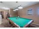 This game room features a classic pool table with overhead lighting and neutral color palette at 5139 W Shumway Farm Rd, Laveen, AZ 85339