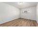 This bedroom is bright with light and features wood-look floors at 520 N Stapley Dr # 123, Mesa, AZ 85203