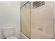 Bathroom featuring a shower-tub combo with glass doors at 6857 S Roosevelt St, Tempe, AZ 85283