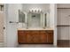 Bathroom featuring a dual sink vanity and large mirror at 6857 S Roosevelt St, Tempe, AZ 85283