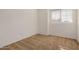 This bedroom features carpet flooring and natural light from the window at 6857 S Roosevelt St, Tempe, AZ 85283