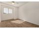Cozy bedroom featuring carpet, a ceiling fan, and a window at 6857 S Roosevelt St, Tempe, AZ 85283