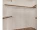 A simple walk-in closet with wood shelving and rods at 6857 S Roosevelt St, Tempe, AZ 85283