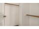 This walk-in closet has wooden rods and shelving at 6857 S Roosevelt St, Tempe, AZ 85283