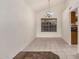 Dining area features tiled floors, a decorative chandelier, and large windows, perfect for Gathering meals at 6857 S Roosevelt St, Tempe, AZ 85283