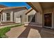 Covered entry with a decorative brick walkway and a wooden front door at 6857 S Roosevelt St, Tempe, AZ 85283