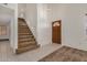 Spacious entryway featuring tile floors, staircase, and a wooden front door at 6857 S Roosevelt St, Tempe, AZ 85283