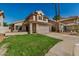 Charming home with a tile roof, two-car garage and a green lawn at 6857 S Roosevelt St, Tempe, AZ 85283